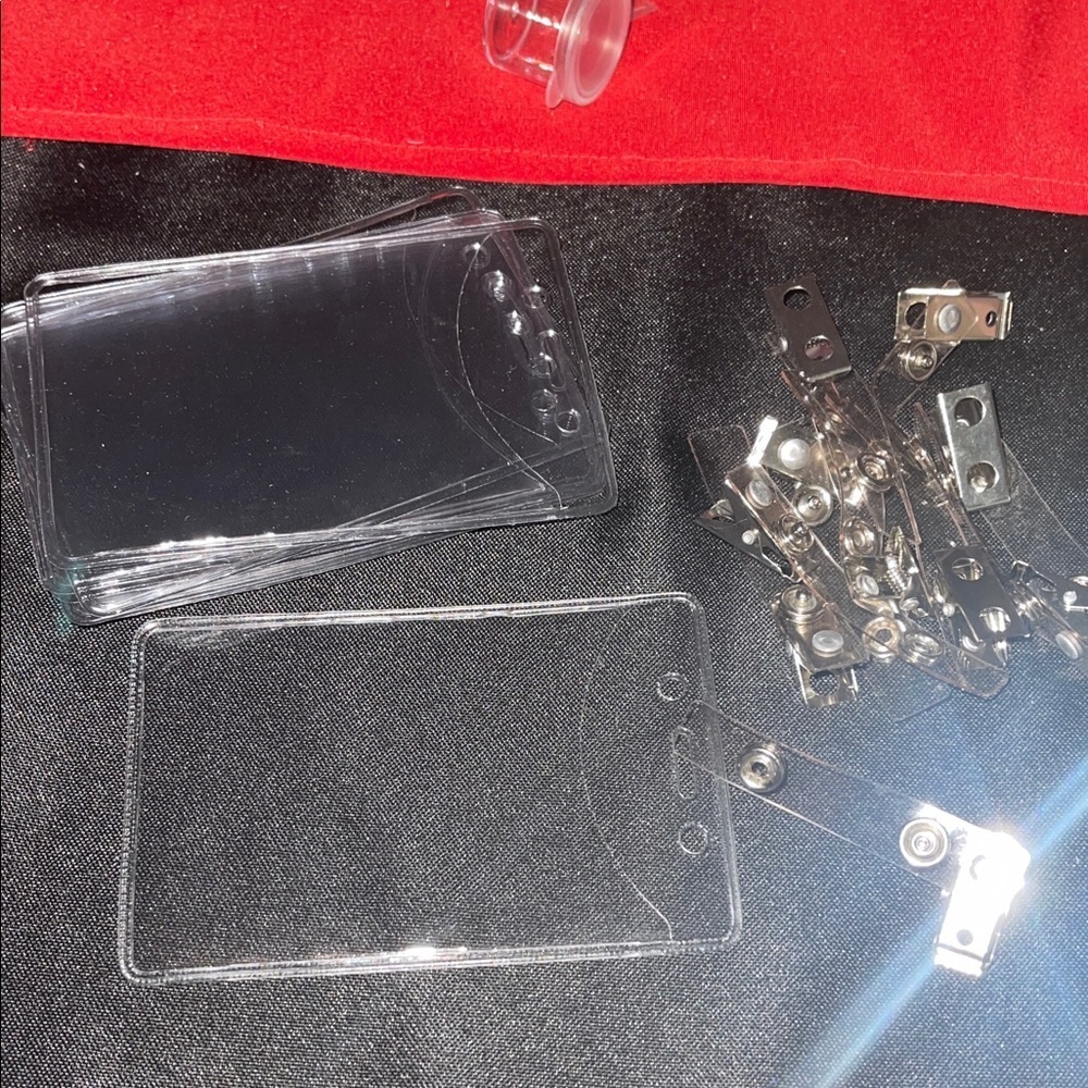 Clear Badge Holders with Clips, New. Set includes 10 pouches and 10 clips.